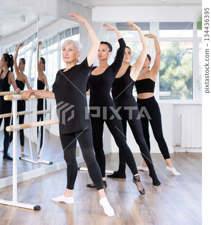 Girls in ballet class perform Batman with participation of mature female mentor Girls in ballet class perform Batman with participation of mature female mentor 134436395