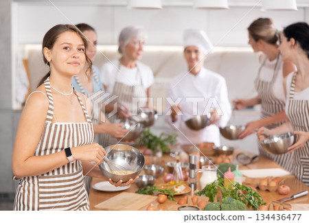 Young woman learns to cook at master class Young woman learns to cook at master class 134436477