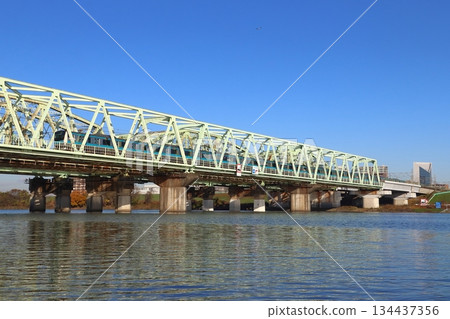Keihin-Tohoku Line E233 series train crossing the Arakawa Bridge in winter 134437356