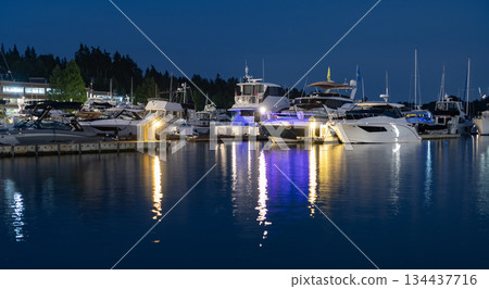 Luxury yacht at night. Night view. Yacht club. Marina in night. Summer vacation. Downtown city marina with luxury illuminated yacht. Docked vessels. Luxury yacht in night marina. Evening yachting 134437716