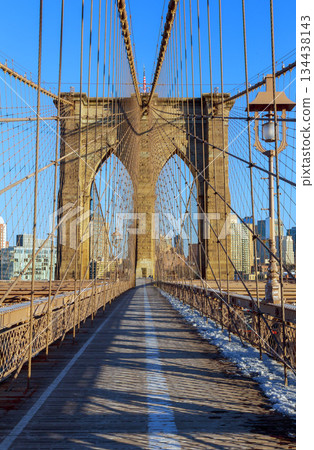 View from middle of Brooklyn Bridge on clear day with city skyline 134438143
