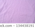 Purple fold knitted fabric background and texture.The fabric features a prominent vertical rib texture. 134438191