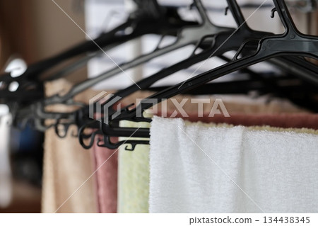 Several face towels hanging to dry indoors 134438345