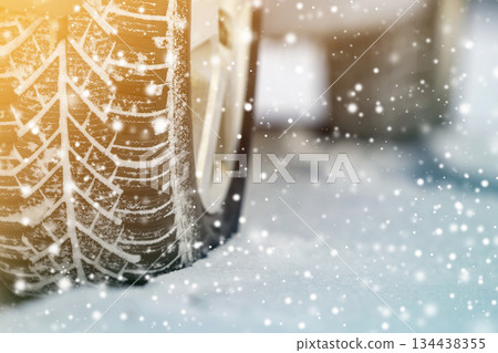 Close-up of car wheels rubber tires in deep winter snow. Transportation and safety concept. 134438355