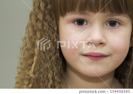 Close up portrait of happy smiling little girl with beautiful thick hair Close up portrait of happy smiling little girl with beautiful thick hair 134438393