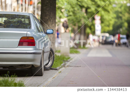 Car parked on green street in pedestrian zone with walking people on summer day. Car parked on green street in pedestrian zone with walking people on summer day. 134438413