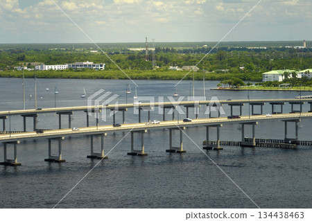Barron Collier Bridge and Gilchrist Bridge in Florida with moving traffic. Transportation infrastructure in Charlotte County connecting Punta Gorda and Port Charlotte over Peace River Barron Collier Bridge and Gilchrist Bridge in Florida with moving traffic. Transportation infrastructure in Charlotte County connecting Punta Gorda and Port Charlotte over Peace River 134438463