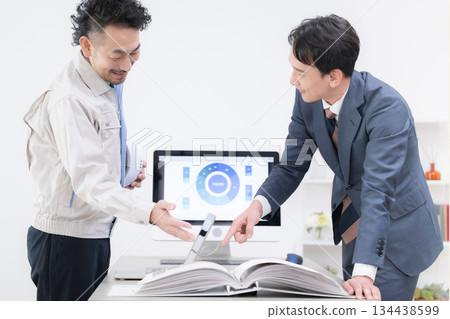 Image of consultant pointing at documents to explain strategy negotiations, business meeting 134438599
