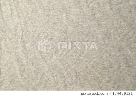 High-resolution.Top view of a light gray heathered fabric, likely a jersey knit used for t-shirts or activewear. High-resolution.Top view of a light gray heathered fabric, likely a jersey knit used for t-shirts or activewear. 134439121