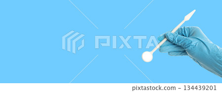 A person holds a dental tool ready for tooth care 134439201