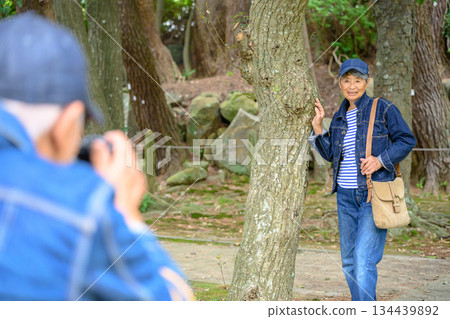 Senior women enjoying taking photos at a shrine 134439892