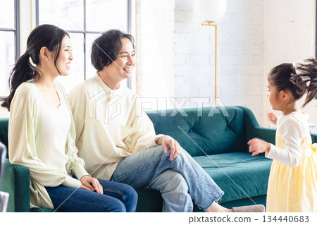 A family relaxing in the living room A family relaxing in the living room 134440683