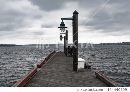 Pier path on promenade avenue with nobody. Sea horizon. Dramatic sky. Pier promenade deck with street lamp at the sea view. Seafront promenade with street lamp Pier path on promenade avenue with nobody. Sea horizon. Dramatic sky. Pier promenade deck with street lamp at the sea view. Seafront promenade with street lamp 134440809