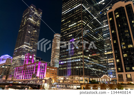 Night cityscape of Chicago skyscraper building. Chicago architecture of skyscraper. City night illuminated building. Skyscraper cityscape. Night city of Chicago. Business city. Neon reflections Night cityscape of Chicago skyscraper building. Chicago architecture of skyscraper. City night illuminated building. Skyscraper cityscape. Night city of Chicago. Business city. Neon reflections 134440814