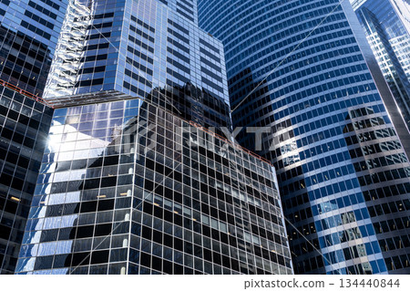 Building background. Glass building window. Architectural detail. Background of architecture. Modern glass background. Glass facade background. Architecture. Building architecture. Business district Building background. Glass building window. Architectural detail. Background of architecture. Modern glass background. Glass facade background. Architecture. Building architecture. Business district 134440844