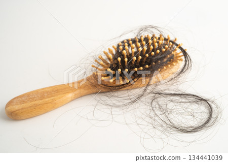Hair loss fall with comb brush isolated on white background. Hair loss fall with comb brush isolated on white background. 134441039
