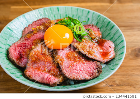 Roast beef bowl topped with egg yolk Roast beef bowl topped with egg yolk 134441591