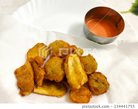 Banana Fritters Served with Spicy Red Chutney 134441755