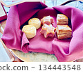 An afternoon tea plate of baked goods wrapped in cloth 134443548