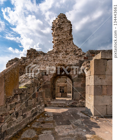 Acropolis of Pergamon ruins with stone walls and archway under a cloudy sky, Bergama, Turkey. Acropolis of Pergamon ruins with stone walls and archway under a cloudy sky, Bergama, Turkey. 134443661