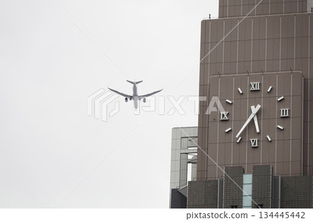 Skyscrapers and flying passenger planes Skyscrapers and flying passenger planes 134445442
