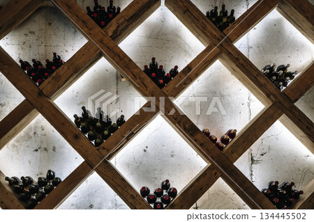 Modern Wine Cellar Display with Wooden Grid and Backlighting 134445502