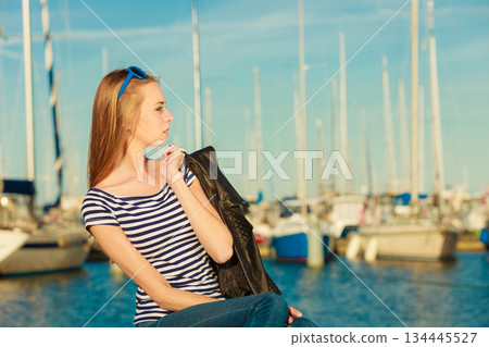 woman in marina against yachts in port woman in marina against yachts in port 134445527