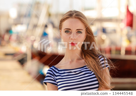 woman in marina against yachts in port 134445548