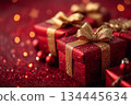 Red gift box with gold bow on top of red background 134445634