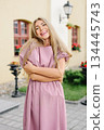 Smiling Woman In Short Mauve Dress Outdoors 134445743