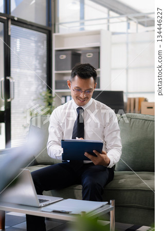 Businessman using laptop computer in office. Happy man, entrepreneur, small business owner working online. 134446227