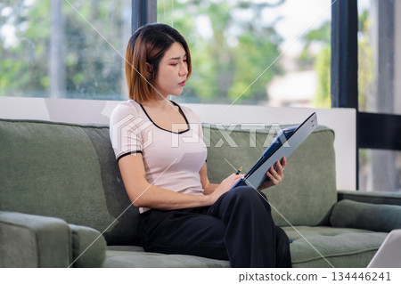 businesswoman thinking ideas and strategy in a modern office. planning, productivity, and success. businesswoman thinking ideas and strategy in a modern office. planning, productivity, and success. 134446241