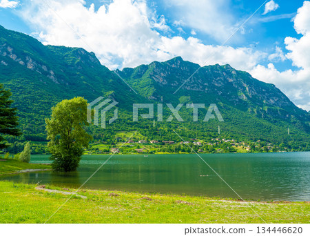 Serene Lake Idro Surrounded by Majestic Mountains and Cloudy sky, Italy, Crone Serene Lake Idro Surrounded by Majestic Mountains and Cloudy sky, Italy, Crone 134446620