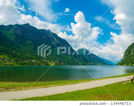 Serene Lake Idro Surrounded by Majestic Mountains and Cloudy sky, Italy, Crone Serene Lake Idro Surrounded by Majestic Mountains and Cloudy sky, Italy, Crone 134446713