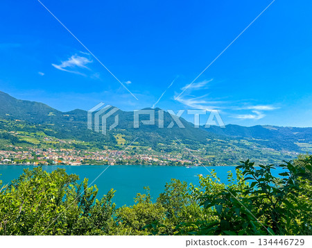 View of Iseo Lake Surrounded by Majestic Mountains and Clear Blue Skies, Italy View of Iseo Lake Surrounded by Majestic Mountains and Clear Blue Skies, Italy 134446729