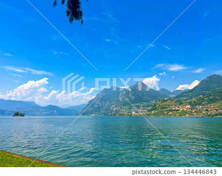 View of Iseo Lake Surrounded by Majestic Mountains and Clear Blue Skies, Italy 134446843