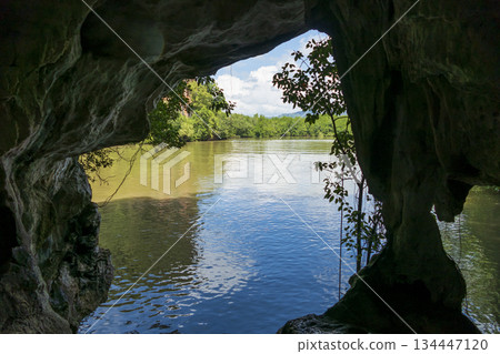 View of the river through the cave on the background of blue sky, Thailand View of the river through the cave on the background of blue sky, Thailand 134447120