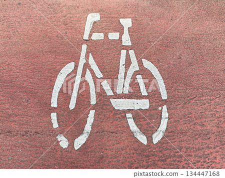 White Stencil Bicycle Lane Symbol on Red Asphalt Pavement 134447168
