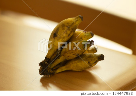 Ripe Thai Namwa Bananas on Wooden Table Ripe Thai Namwa Bananas on Wooden Table 134447988