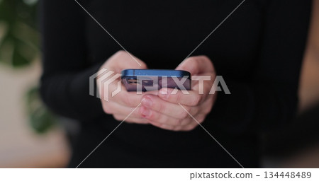Close-up of young women hand. Hand of woman using texting mobile smartphone or chatting. Reading social media internet, typing text or shopping online. Close-up of young women hand. Hand of woman using texting mobile smartphone or chatting. Reading social media internet, typing text or shopping online. 134448489