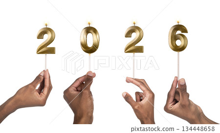 Close-up of fingers holding shiny 2026 candles symbolizing start of new year, celebration, joy and 134448658