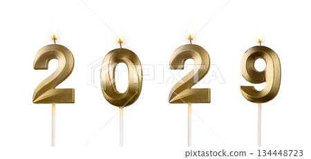 Glossy number candles 2029 illuminated with warm flame, symbol of festive celebration, joy, and New 134448723