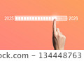 Loading bar symbol of transition. Female hand touching digital screen, representing 2025 to 2026 134448763