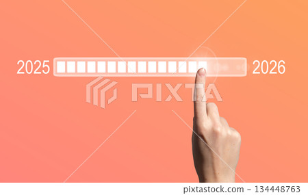 Loading bar symbol of transition. Female hand touching digital screen, representing 2025 to 2026 134448763