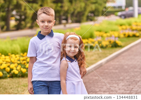 Caucasian young boy and girl smiling outdoors in park on a sunny day 134448831