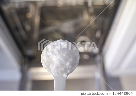 Dishwasher and detergent scoop in kitchen clean dishes with efficient washing 134448904