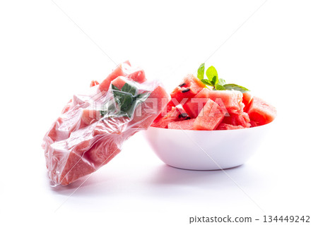 frozen watermelon in a vacuum bag and fresh in a plate 134449242