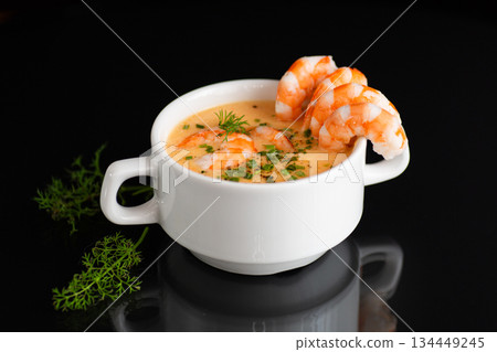 Gourmet seafood soup featuring tender shrimp and aromatic green herbs Gourmet seafood soup featuring tender shrimp and aromatic green herbs 134449245