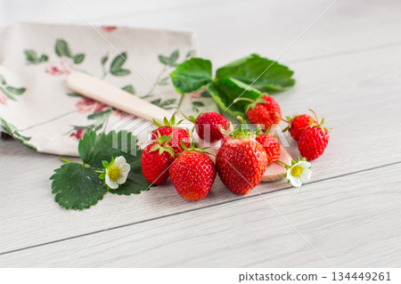 Ripe red strawberries on a light wooden table 134449261