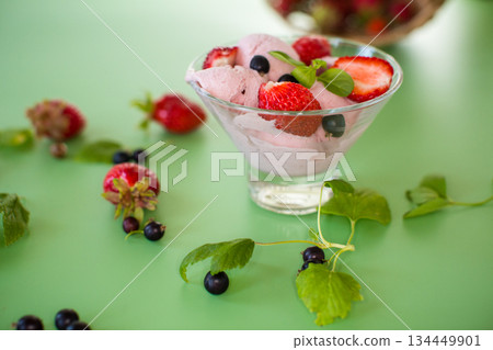 Sweet ice cream made from strawberries and black currants 134449901